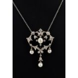 An early 20th century Belle Epoque diamond & pearl openwork pendant, 38mm long, on associated chain,