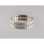 Property of a lady - an unmarked platinum diamond eternity ring, size M.