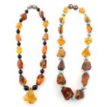 Property of a lady - two modern amber necklaces, the largest nugget approximately 38mm long (2).