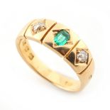 An 18ct yellow gold emerald & diamond three stone gipsy set ring, the octagonal cut emerald
