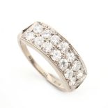 An 18ct white gold panel ring, the curved rectangular panel pave set with fourteen round brilliant