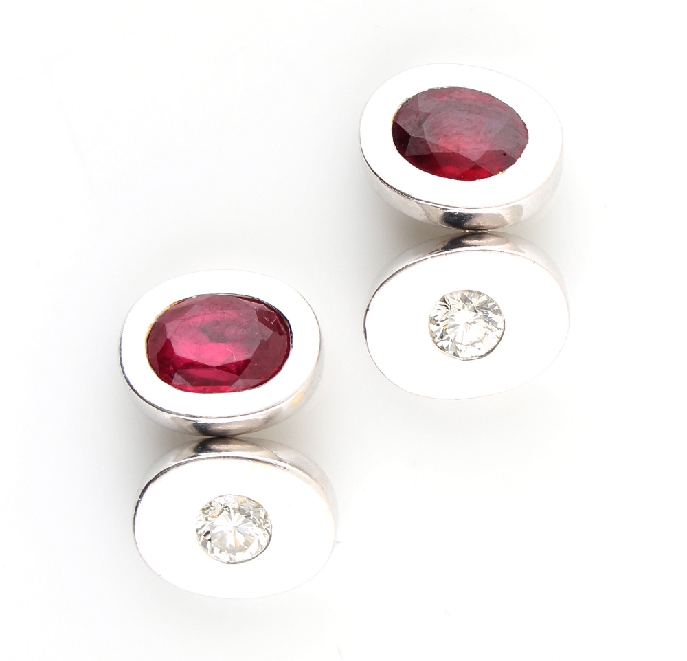 A pair of 18ct white gold ruby & diamond oval panelled cufflinks, the two oval cut rubies each