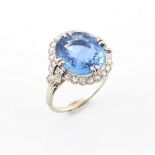 A very good white gold sapphire & diamond ring, the large oval cut sapphire weighing approximately