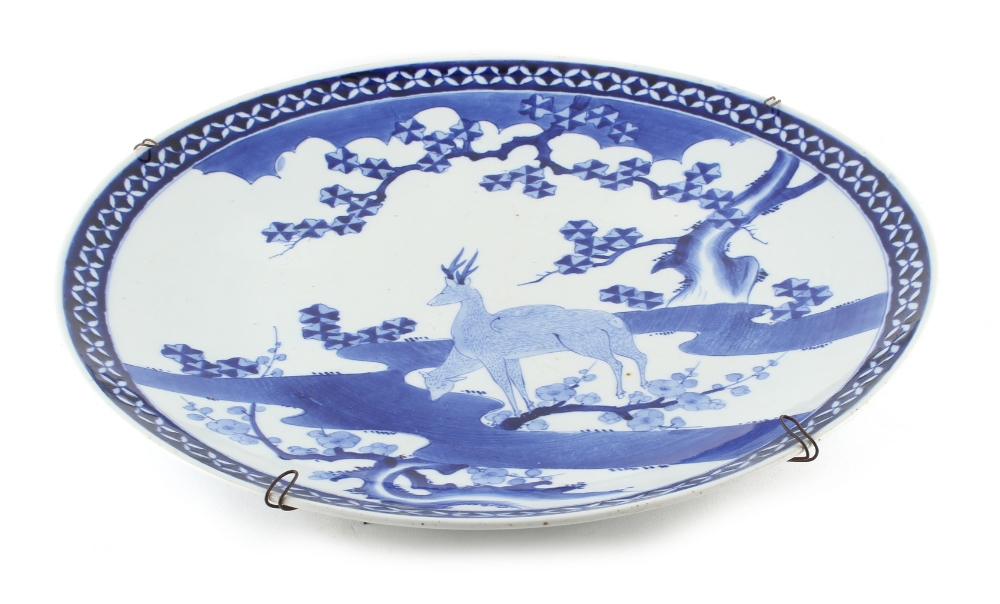 Property of a lady - a large Japanese blue & white charger, circa 1900, painted with two deer by a - Image 2 of 3