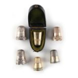 Property of a lady - a cased yellow metal thimble; together with two further yellow metal
