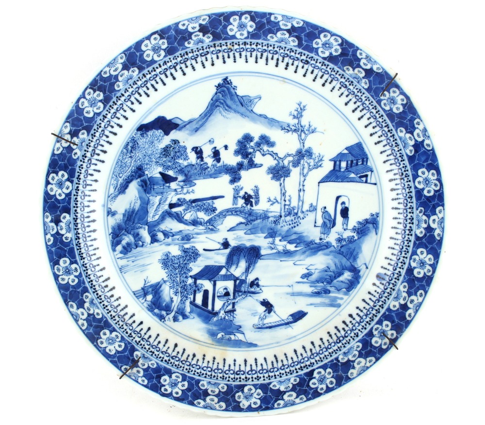 Property of a lady - a Chinese blue & white plate, painted with figures in a river landscape, 4-