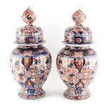 Property of a lady - a pair of 19th century Japanese Imari ribbed vases or jars & covers, 11.