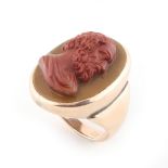 A 9ct yellow gold cameo ring, the oval panel with high relief red bust of a classical gentleman,