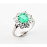 A white gold certificated Colombian emerald & diamond cluster ring, the rectangular cut emerald
