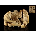 Property of a lady - a Japanese carved ivory okimono depicting a child & two monkeys playing