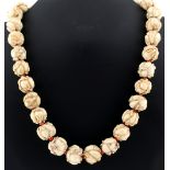 A Japanese carved ivory ojime bead necklace, the thirty beads each carved as entwined mice or
