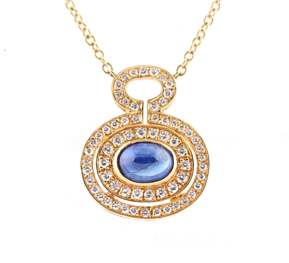 An 18ct yellow gold sapphire & diamond pendant necklace, the oval cabochon sapphire weighing