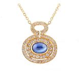 An 18ct yellow gold sapphire & diamond pendant necklace, the oval cabochon sapphire weighing