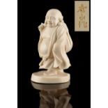 Property of a gentleman - an early 20th century Japanese carved ivory okimono depicting Hotei,