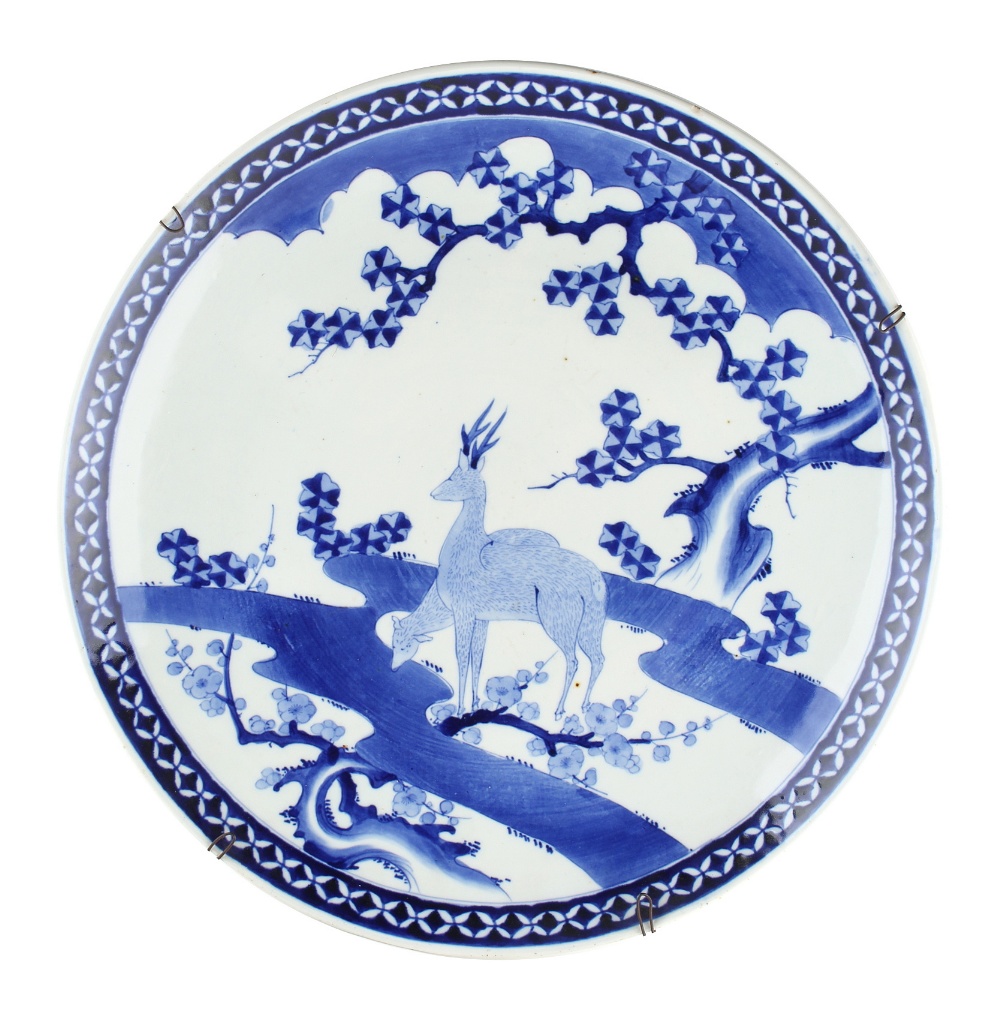 Property of a lady - a large Japanese blue & white charger, circa 1900, painted with two deer by a