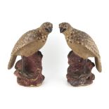 Property of a lady - a pair of early 20th century Japanese pottery models of perched hawks,