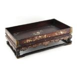 A 19th century Chinese lac burgaute opium tray, 12.25ins. (31.1cms.) long.