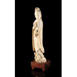 A 19th century Chinese carved ivory figure of Guanyin, modelled standing on a dragon & holding a