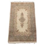 Property of a deceased estate - a Persian Qum rug with floral pattern on an ivory ground with pale