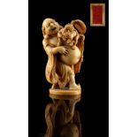 Property of a lady - a Japanese carved ivory okimono depicting Hotei with two oni, late Edo /