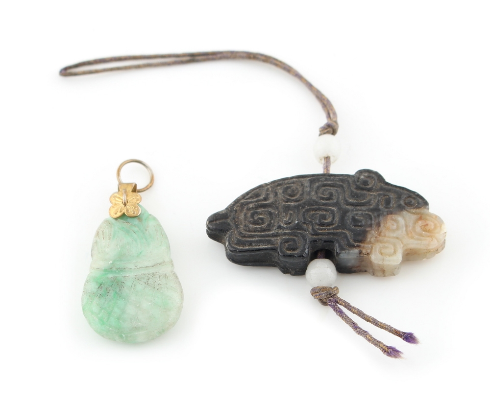 Property of a lady - a Chinese carved russet & white jade pendant in the form of an animal, 40mm