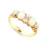 An 18ct yellow gold opal & diamond ring, the two oval opals alternating with a pair & two single old