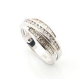 Property of a lady - an 18ct white gold diamond set three band crossover ring, approximately 4.0