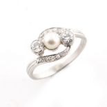A pearl & diamond crossover ring, the central pearl flanked by two Old European cut diamonds in