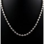 Cartier - a fine 18ct white gold diamond necklace by Cartier, the sixty-two round brilliant cut
