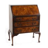 Property of a lady of title - a walnut fall-front bureau, on cabriole legs.