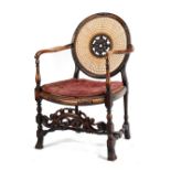 Property of a lady - an early 20th century carved & cane panelled elbow chair.