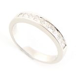 Property of a gentleman - a modern 18ct white gold diamond half eternity ring, set with nine