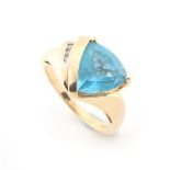 Property of a lady - a 14ct yellow gold blue topaz & diamond dress ring, set with a triangular cut