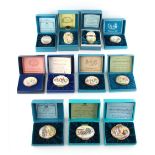 Property of a lady - a collection of nine Halcyon Days Bilston & Battersea enamel Christmas boxes;