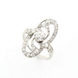 Property of a lady - an Art Deco white gold diamond scrolling openwork ring, the central Old