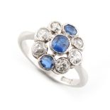 An 18ct white gold sapphire & diamond cluster ring, with three cushion cut sapphires & six Old