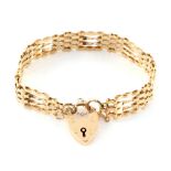 Property of a lady - a 9ct yellow gold gate link bracelet with heart shaped lock, approximately 16.8