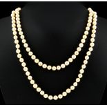Property of a deceased estate - a cultured pearl long single strand twin clasp necklace, the uniform