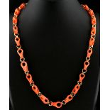 An unusual carved coral chain link necklace, 17.75ins. (45cms.) long, approximately 15.0 grams.