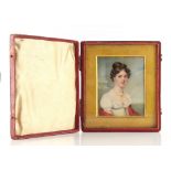 Property of a lady - a 19th century portrait miniature on ivory depicting a young lady, in red