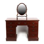 Property of a gentleman - a late Victorian mahogany kneehole dressing table, with nine drawers,