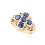 An unmarked yellow gold sapphire five stone ring, the five cushion cut sapphires arranged in the