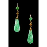 A pair of Chinese carved untreated jadeite pendant earrings, each 48mm long (2).