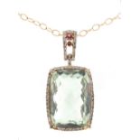 Property of a lady - a large 14ct yellow gold blue topaz pendant of cut rounded rectangular form set