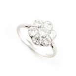 An 18ct white gold diamond flowerhead cluster ring, the seven round brilliant cut diamonds