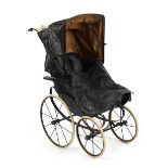 Property of a lady - a late 19th / early 20th century black painted doll's push chair, with white