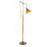 Property of a deceased estate - a brass adjustable standard lamp, with amber glass shade.