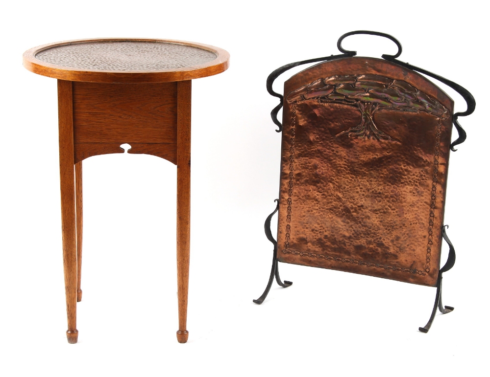 Property of a gentleman - an Art Nouveau oak circular topped occasional table, with inset hammered