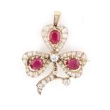 An early 20th century ruby & diamond cloverleaf brooch with suspension loop to be worn as a pendant,