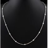 An 18ct white gold diamond chain necklace, the sixteen round brilliant cut diamonds weighing a total